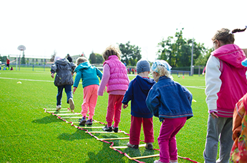children playing in grass